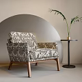 Stylish Accent Chair with Intricate Patterns Wooden Legs and Side Table Plant