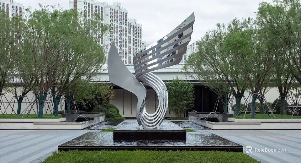 Streamlined Silver Metal Sculpture In Outdoor Space With Water Fountain Trees And High Rise Buildings 3d model 