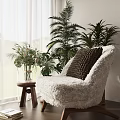 Cozy Leisure Chair With Brown Knitted Cushion Vase White Green Flowers Green Plants Natural Light