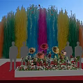 Colorful Fountain Launch Device With Flower Display And People Silhouettes Under Blue Sky