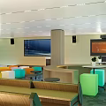 Modern Conference Room With Colorful Seats Large Screen Podium And Bright Lighting