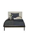 Minimalist Single Bed with Upholstered Headboard Gray Blanket White Sheets and Decorative Pillows