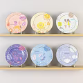 Colorful Decorative Plates With Various Cute Patterns On Two Wooden Shelves