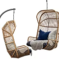 Stylish Rattan Hanging Chair With Blue Cushions And Gray Throw Blanket On Black Metal Stand