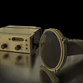 Vintage Electronic Device With Control Knobs And Metallic Reflective Disc