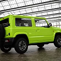 Green Suzuki Jimny Off Road Vehicle Parked In Industrial Style Garage With Large Windows