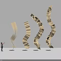 Spiral Wooden Art Installation Made Of Book Pages With Curved Upward Design And Person Nearby