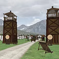 Wooden Watchtowers In Mountain Landscape With Fenced Campsite And Tents