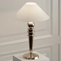 Modern Table Lamp With White Lampshade And Metal Base On White Wall Background
