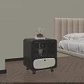 Modern Double Bed With Beige Upholstered Headboard And Black Nightstand With Books And Dried Flowers