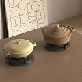 Ceramic Cooking Pots With Lids On Black Bases On Wooden Tabletop In Kitchen