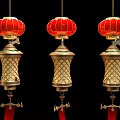 Three Red Chinese Lanterns With Golden Ornate Bodies And Red Tassels