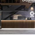 Modern Café Interior Featuring Wooden Counter Glass Display Case Fresh Pastries Staircase And Neon Lighting
