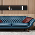 Blue Tufted Two Seater Sofa with Red Cushions Wooden Wall Black Shelf and Round Mirror