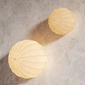 Round Beige Striped Design Wall Lamps On Gray Wall For Soft Decorative Lighting