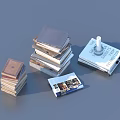 Assorted Stacks of Books and Open Magazine with Colored Covers and Layouts