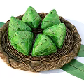 Fresh Zongzi Wrapped in Green Bamboo Leaves Placed in Woven Basket with Leaves Around