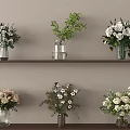 Various Flowers in Different Vases on Wooden Shelves with White Roses and Green Leaves