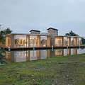 Modern Semi Detached Villa Exterior With Glass Curtain Walls Water Pond Green Lawn And Trees