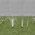 Grass And Reed Shaped Outdoor Lights With White Light On Green Grass And Gray Wall