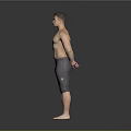 Shirtless Man Standing with Hands Behind Back in Gray Tight Pants on Gray Background