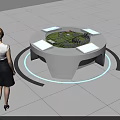 Woman Observing Interactive Sand Table With Circular Design Surrounding Screens And Green Terrain Building Model