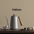 Poliform Decorative Ornament Set Including Silver Kettle Wooden Handle Glass Cup Open Magazine On Table