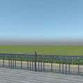 Black Iron Decorative Fence With Blue Flowers Along Green Grass On Wooden Deck
