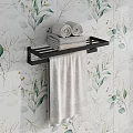 Modern Black Towel Rack With Rolled And Folded Towels On Green Leaf Pattern Wallpaper