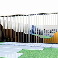Modern Garden Fence Design With Vertical Metal Slats Backdrop Of Hills Buildings Grass Stone Pathway