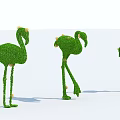 Three Flamingo Shaped Topiary Shrubs With Yellow Flowers In Different Poses