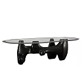 Modern Coffee Table Featuring Glass Top and Unique Black Sculptural Base