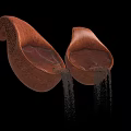 Brown Teardrop Shaped Objects With Textured Surface And Water Dripping Below