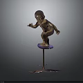 Bronze Child Statue With Metal Base And Three Supporting Feet On Dark Background