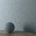 Gray Spherical Component Placed On Wooden Surface Against Textured Wall
