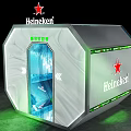 Female Character In Transparent Cylindrical Device With Green Lines Heineken Logo Starry Sky Mountain Background