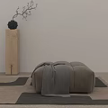 Minimalist Gray Ottoman With Draped Blanket On Geometric Rug Near Wooden Pillar And Black Vase