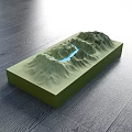 Green Mountain Terrain Commercial Equipment With Blue Water Flow Lines On Dark Wooden Floor