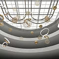 Hanging Art Installation With Golden Circular Rings And Wire Mesh Spheres In Indoor Space