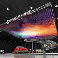 Modern Exhibition Booth With Colorful Hanging Light Decorations Red Car Display Tables Chairs And Green Plants