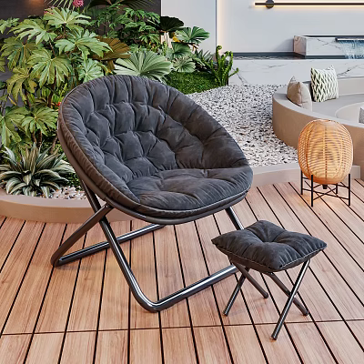 Black Padded Lounge Chair With Small Ottoman On Wooden Deck Surrounded By Green Plants 3d model