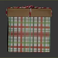 Festive Gift Box With Red And Green Plaid Pattern And Red White Striped Ribbon