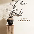 Ceramic Vase With Twig Branches On Wooden Stump Against Light Wall Background