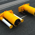 Two Yellow Cylindrical Devices With White Components On Road Surface 3d model