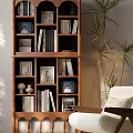 Warm Wooden Bookcase With Multiple Shelves Holding Books Photo Frames Decorative Items And Green Plants