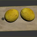 Two fresh yellow melons placed on a natural wooden cutting board