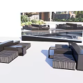 Black Outdoor Sofa Set In Modern Patio With Lush Greenery And Water Feature