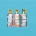 Bfre Beverage Bottles With Pink Beige Grey Colorful Design On Light Blue Background