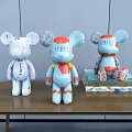 Decorative Ornament Set With Three Cartoon Bear Figurines On Wooden Table And Stacked Books
