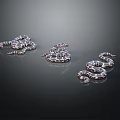 Three Patterned Snakes In Coiled Positions On Dark Reflective Surface Background